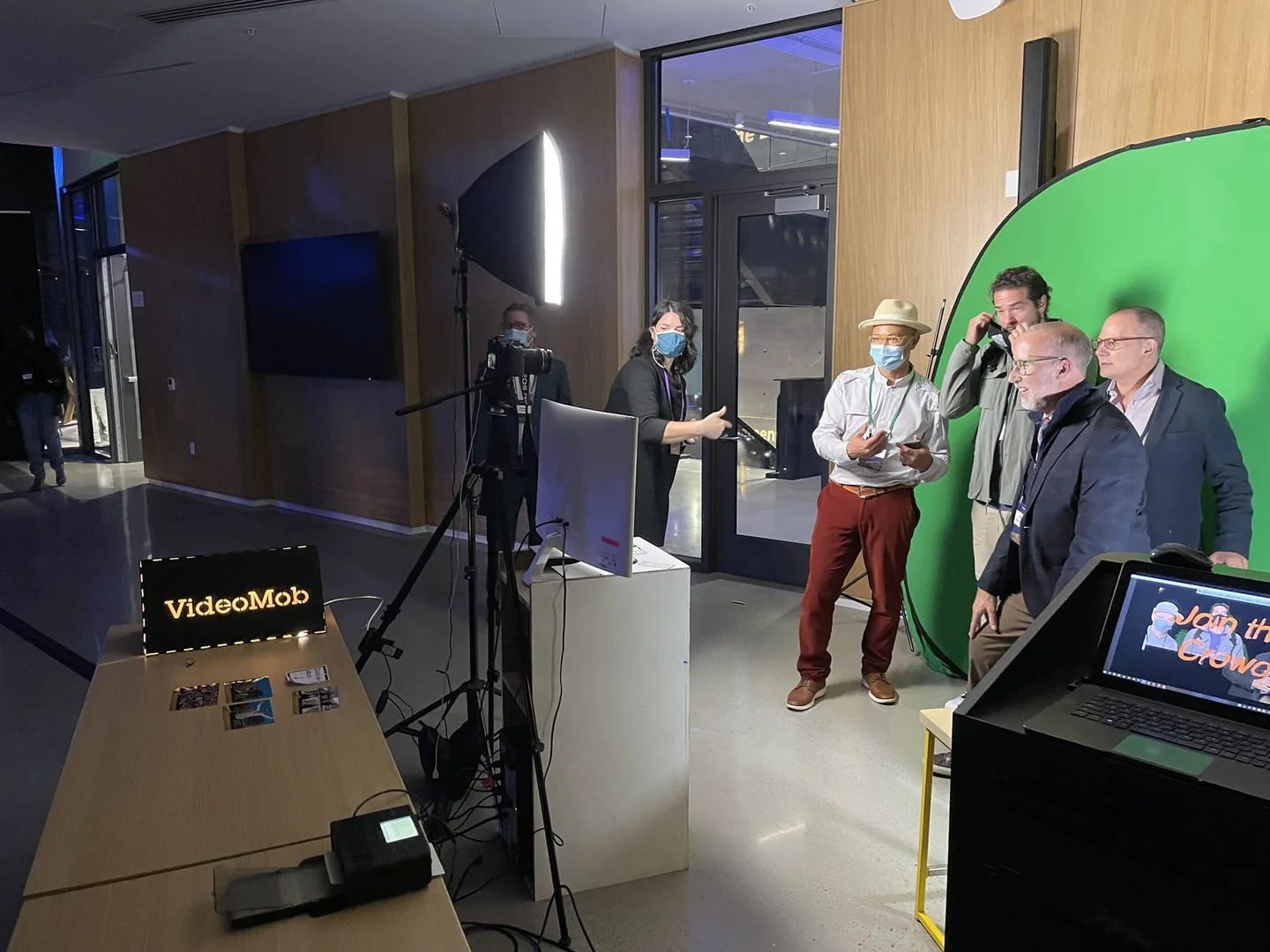 VideoMob's green-screen recording station with camera and lit sign at the Design and Innovation Building grand opening